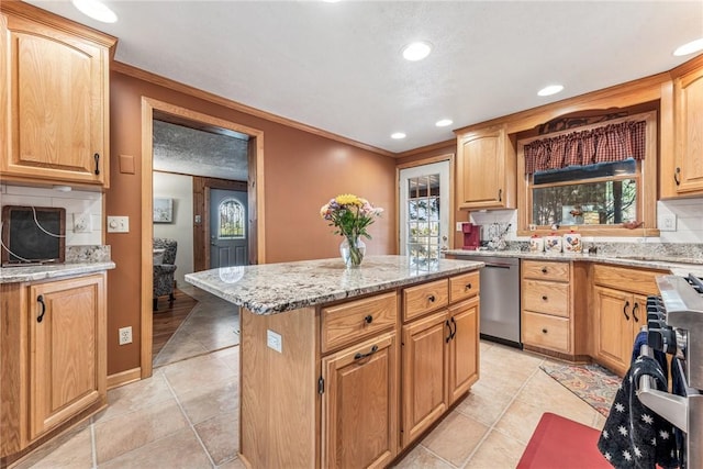 kitchen featuring light tile patterned floors, stainless steel appliances, tasteful backsplash, a kitchen island, and light stone countertops