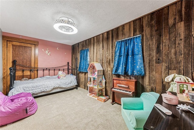 carpeted bedroom with a textured ceiling and wooden walls