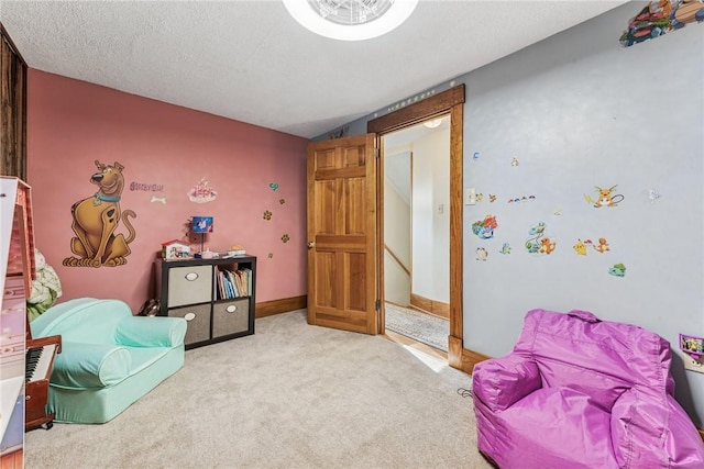 interior space with light carpet, a textured ceiling, and baseboards