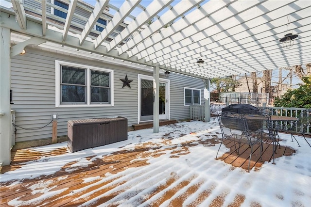 snow covered deck featuring fence and a pergola