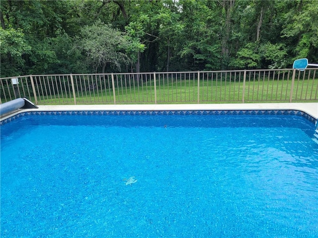 view of swimming pool with a yard and a fenced in pool