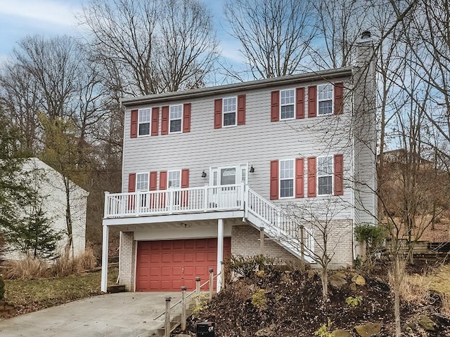 view of front facade with driveway, a garage, a chimney, and brick siding