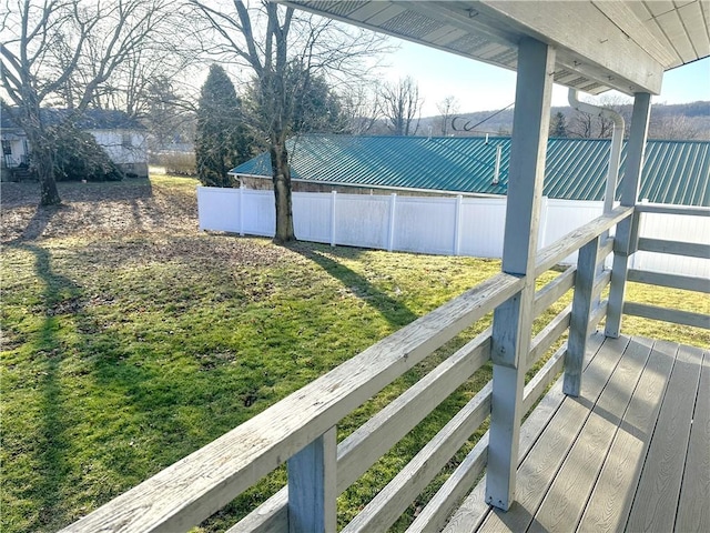 exterior space featuring a lawn and fence