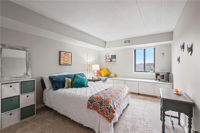 carpeted bedroom featuring visible vents