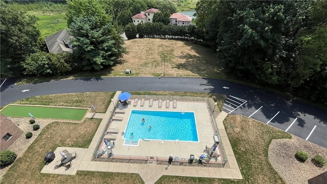 view of pool featuring a lawn