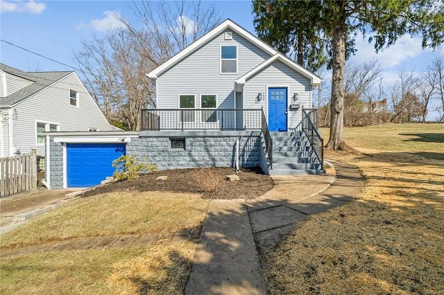 bungalow-style house with a garage, a front lawn, and concrete driveway