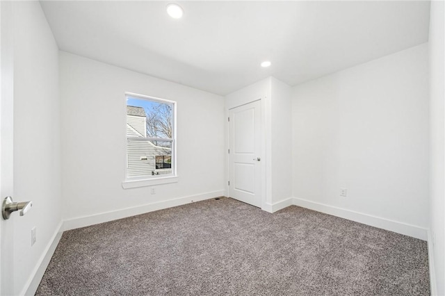 carpeted empty room with recessed lighting and baseboards