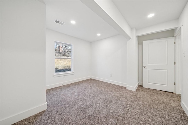 carpeted empty room with visible vents, baseboards, and recessed lighting