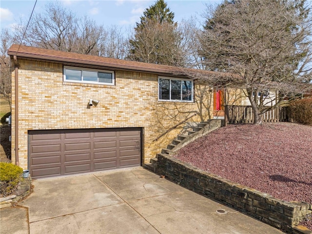 view of front of house with driveway, brick siding, and an attached garage