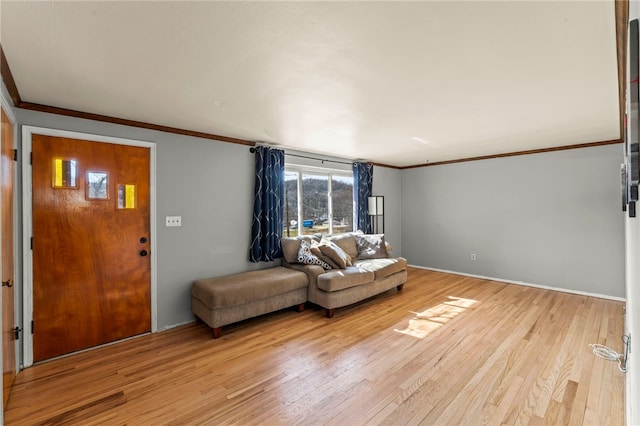 living area with light wood-type flooring and ornamental molding