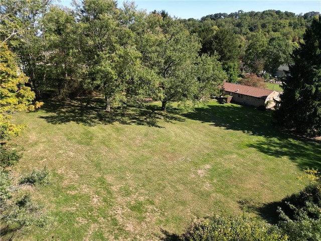 aerial view featuring a wooded view