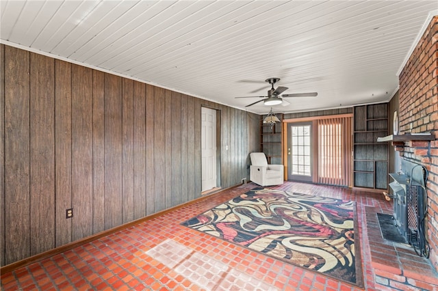 unfurnished room featuring wood walls and ceiling fan