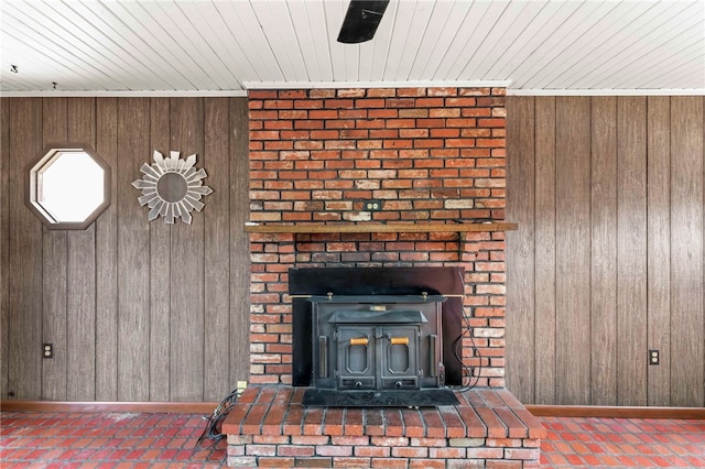 room details featuring baseboards, wood ceiling, and wooden walls