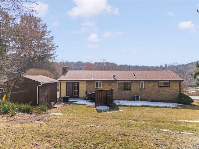 back of house with a patio area, a chimney, cooling unit, and a yard