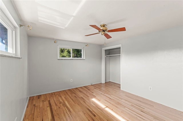 unfurnished bedroom featuring light wood-type flooring, a closet, and ceiling fan