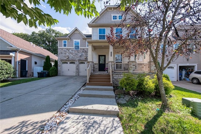 craftsman inspired home with driveway, stone siding, a garage, and a porch