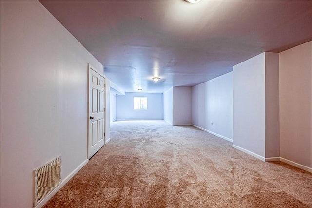 carpeted spare room with baseboards and visible vents