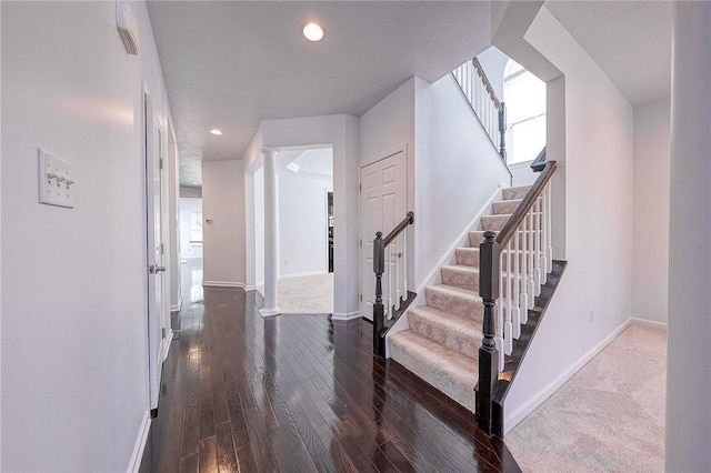 interior space featuring ornate columns, baseboards, hardwood / wood-style floors, and recessed lighting