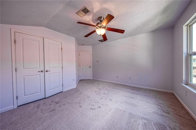 unfurnished bedroom with visible vents, light carpet, baseboards, and multiple windows