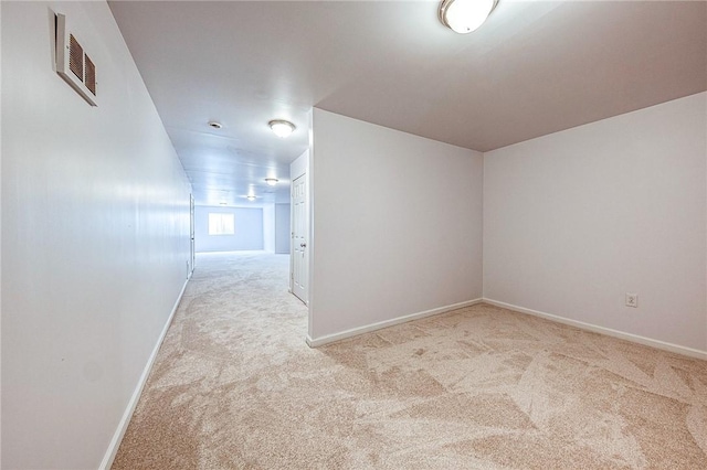 unfurnished room featuring light carpet, visible vents, and baseboards