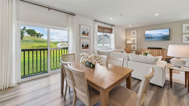 dining area featuring wood finished floors and recessed lighting