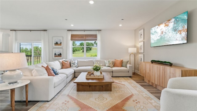 living room with recessed lighting, plenty of natural light, and light wood-style floors