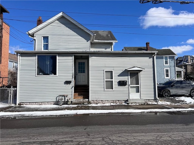 view of front of house featuring entry steps and fence