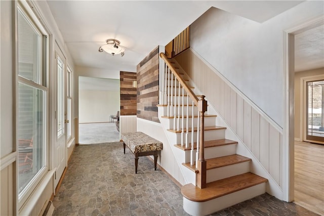 stairway featuring stone finish flooring