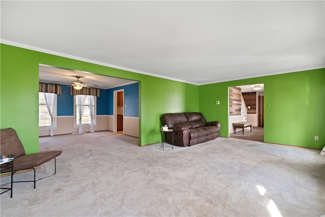 living area with ornamental molding and light carpet