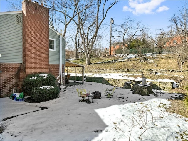 snowy yard with a fire pit