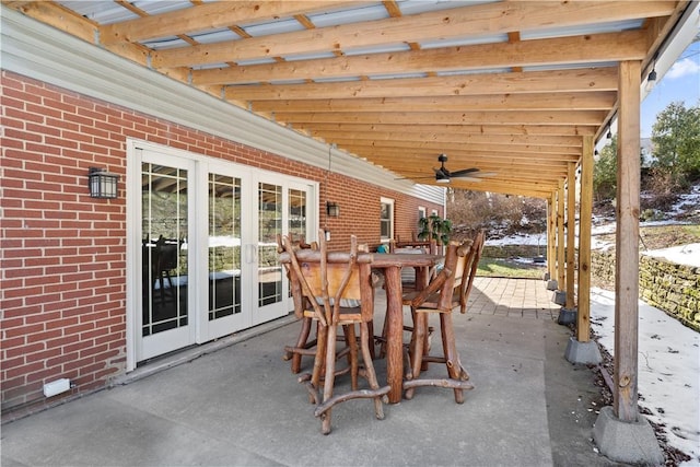 view of patio featuring french doors, outdoor dining area, and a ceiling fan