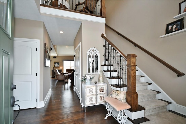 entrance foyer featuring a high ceiling, baseboards, dark wood finished floors, and recessed lighting