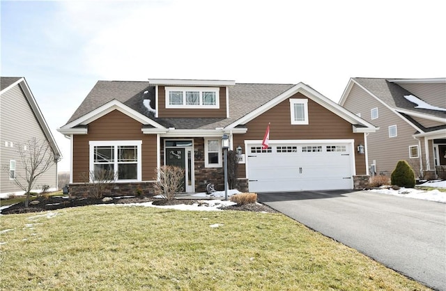 craftsman inspired home featuring driveway, stone siding, a garage, and a front lawn