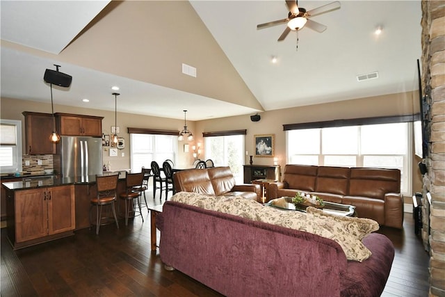 living room featuring a ceiling fan, dark wood-style flooring, and visible vents