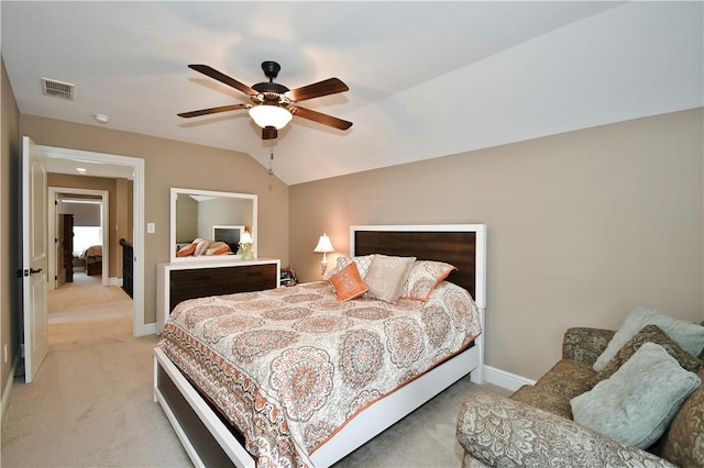 bedroom featuring lofted ceiling, visible vents, light carpet, and baseboards