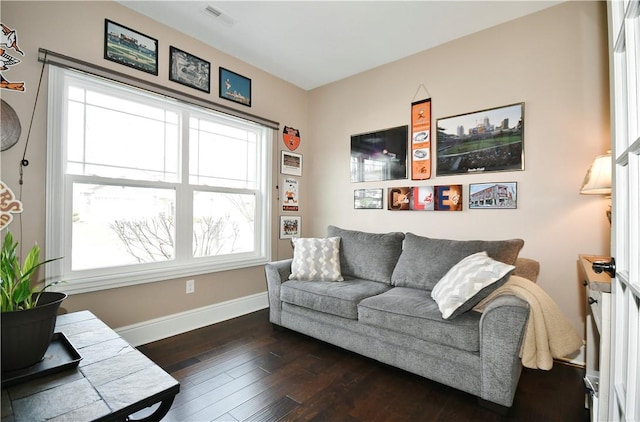 living room with visible vents, baseboards, and dark wood-type flooring