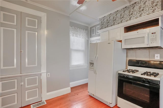 kitchen featuring white appliances, visible vents, white cabinetry, baseboards, and ornamental molding