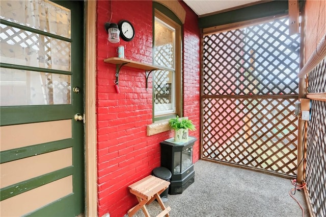 doorway to property featuring brick siding