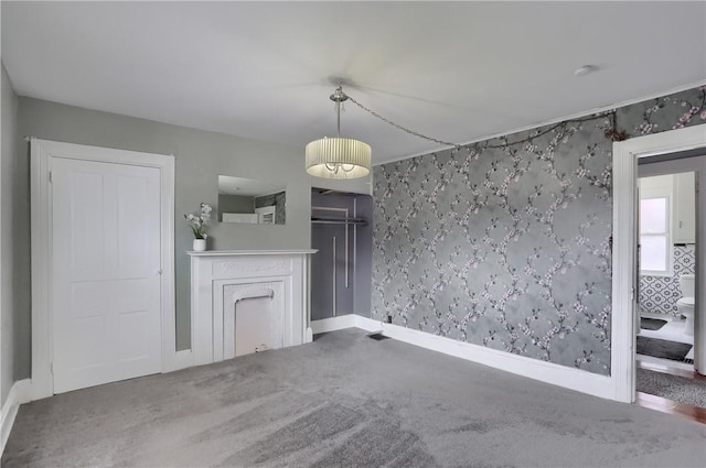 unfurnished dining area featuring carpet, a fireplace, and baseboards