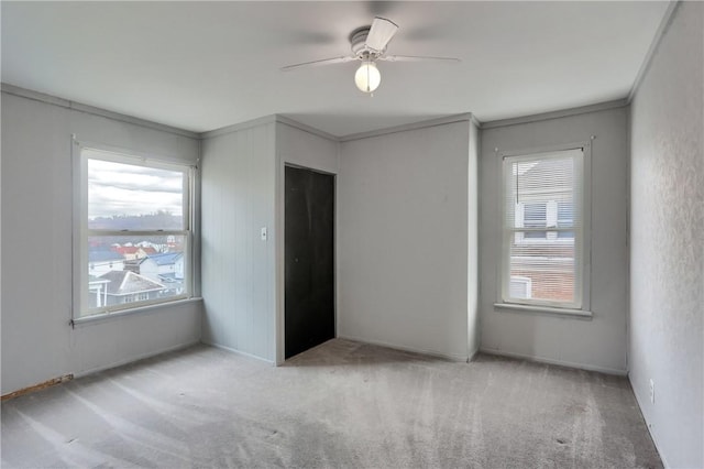 empty room featuring light carpet and ceiling fan