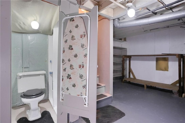 bathroom featuring concrete flooring and toilet