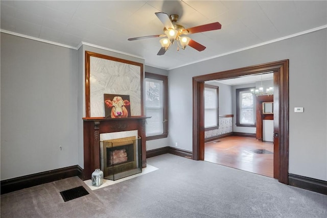 carpeted living area featuring ornamental molding, a fireplace, visible vents, and baseboards