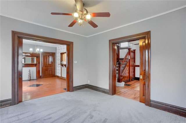 empty room featuring stairway, baseboards, ornamental molding, and carpet flooring