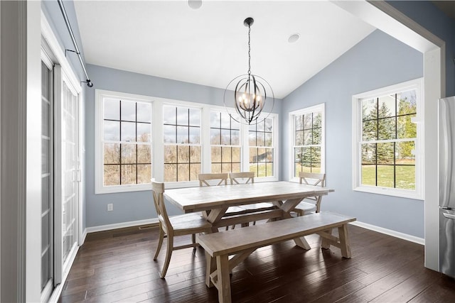 dining area with lofted ceiling, a notable chandelier, baseboards, and dark wood-type flooring