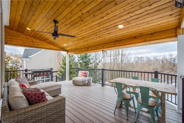 wooden terrace featuring an outdoor hangout area, ceiling fan, and outdoor dining area