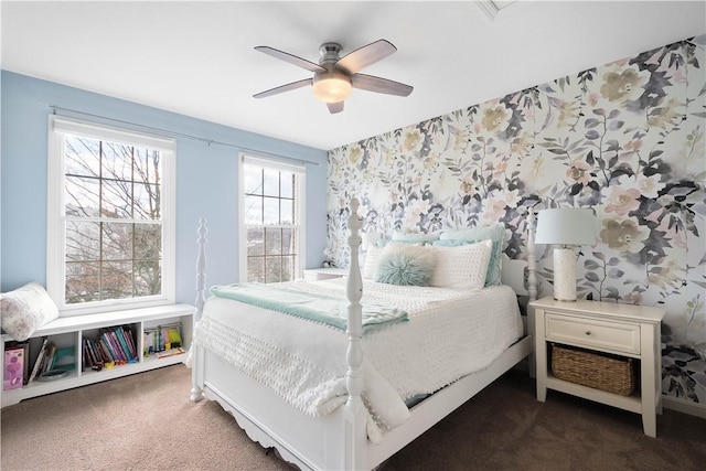 bedroom with ceiling fan, dark colored carpet, and wallpapered walls