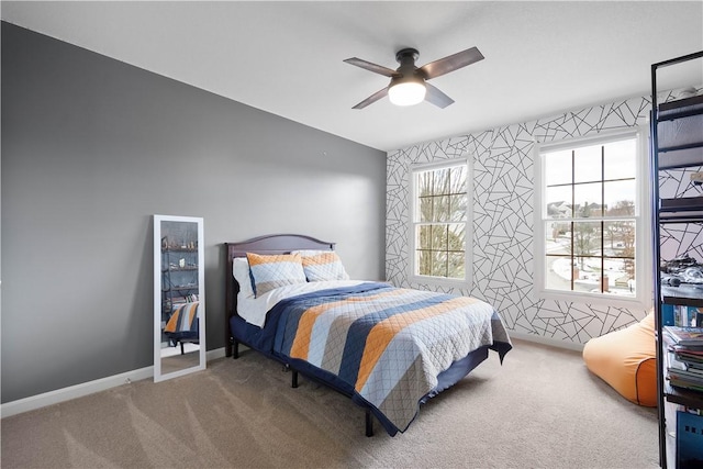 carpeted bedroom with ceiling fan, wallpapered walls, and baseboards