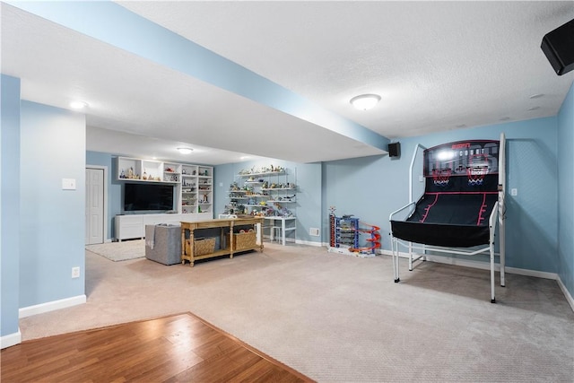 game room featuring a textured ceiling, carpet, built in features, and baseboards