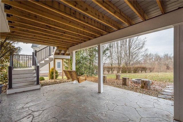 view of patio / terrace with a fire pit and stairs