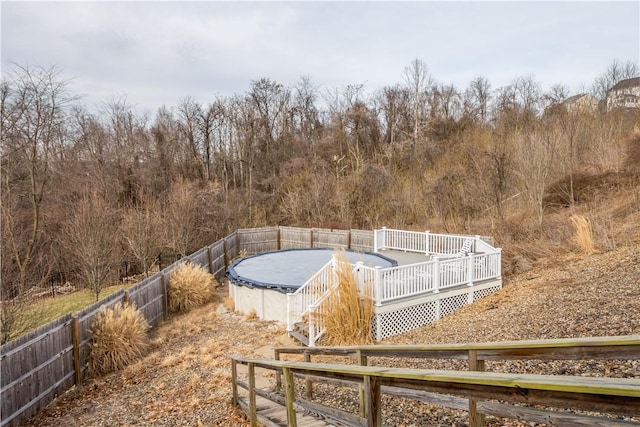 view of yard featuring fence and a wooden deck